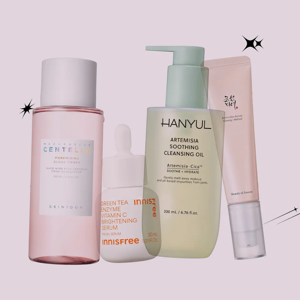 Group of skincare products on a pale pink background: Centella toner, Innisfree serum, HANYUL Artemisia cleansing oil, and a pink tube.