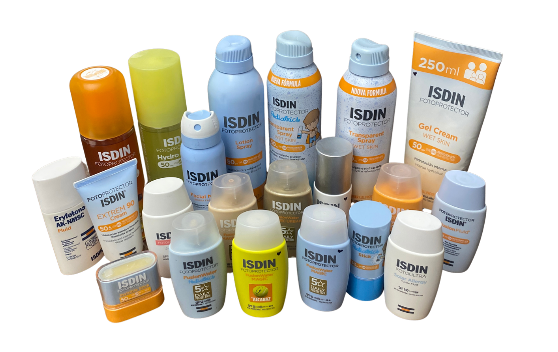 Assorted ISDIN sun protection products—including sprays, lotions, and sticks—arranged on a black background.